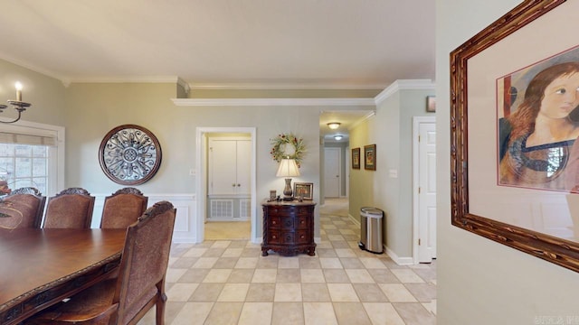 dining space with ornamental molding and wainscoting