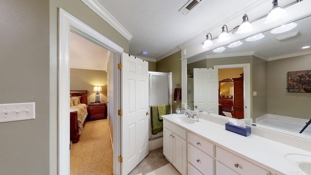 bathroom with a shower stall, a sink, double vanity, and ensuite bath