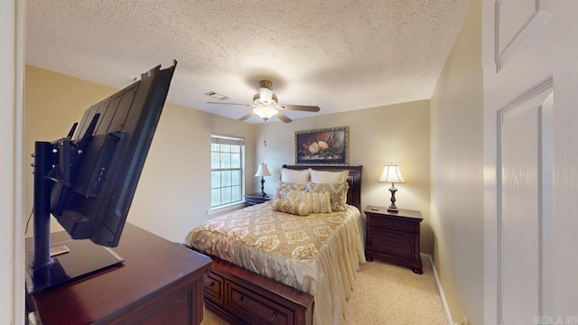 bedroom featuring a textured ceiling, visible vents, a ceiling fan, and light colored carpet