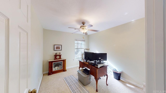 home office with baseboards, carpet floors, and ceiling fan