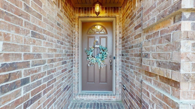 property entrance with brick siding
