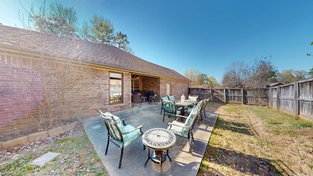 view of yard featuring a fenced backyard, outdoor dining space, and a patio area