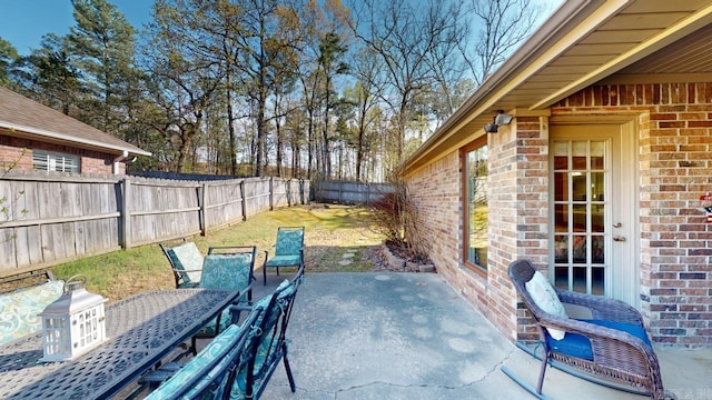view of patio with a fenced backyard and outdoor dining area