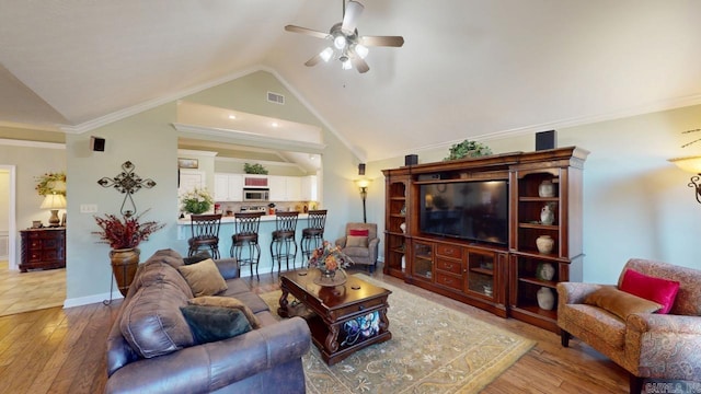 living area with hardwood / wood-style floors, ceiling fan, visible vents, and ornamental molding