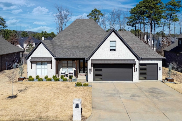18 Ensbury Pl, Little Rock, AR 72223 - view of front of house featuring concrete driveway, a garage, and roof with shingles
