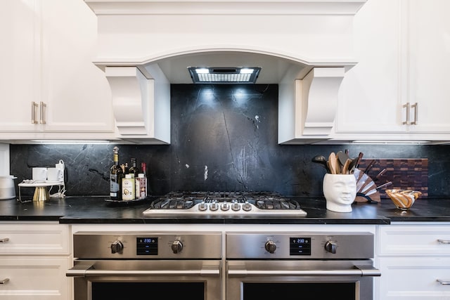 18 Ensbury Pl, Little Rock, AR 72223 - kitchen featuring decorative backsplash, white cabinetry, stainless steel appliances, and dark countertops
