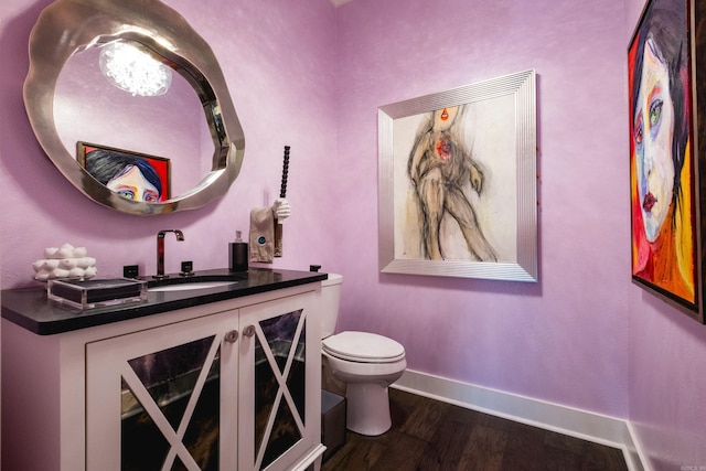 18 Ensbury Pl, Little Rock, AR 72223 - half bath featuring toilet, vanity, baseboards, and wood finished floors