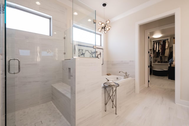 18 Ensbury Pl, Little Rock, AR 72223 - full bath with baseboards, an inviting chandelier, a stall shower, a garden tub, and a spacious closet