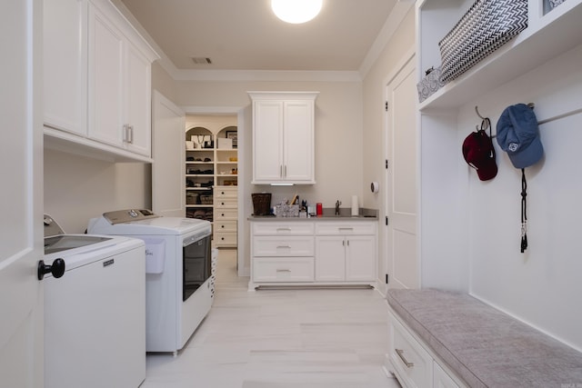 18 Ensbury Pl, Little Rock, AR 72223 - laundry area featuring independent washer and dryer, ornamental molding, a sink, visible vents, and cabinet space