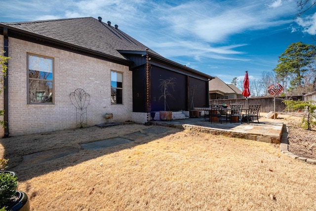 18 Ensbury Pl, Little Rock, AR 72223 - back of property with brick siding, fence, a shingled roof, and a patio area