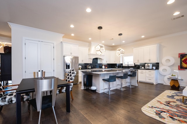 18 Ensbury Pl, Little Rock, AR 72223 - dining space featuring dark wood finished floors, recessed lighting, crown molding, and visible vents