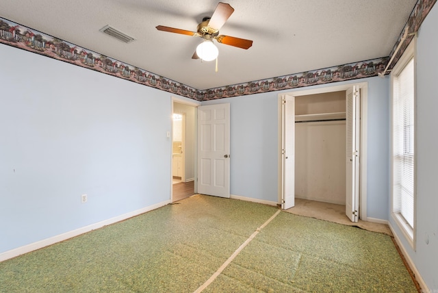 unfurnished bedroom with a closet, a textured ceiling, baseboards, and visible vents
