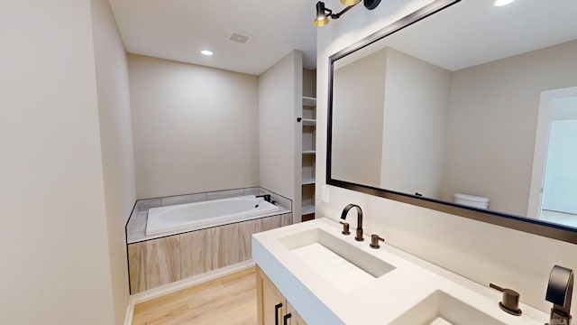 156 Waterfront Dr, Hot Springs, AR 71913 - full bathroom with vanity, a garden tub, wood finished floors, visible vents, and recessed lighting