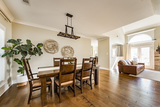 dining area featuring baseboards, visible vents, ornamental molding, and dark wood-style flooring