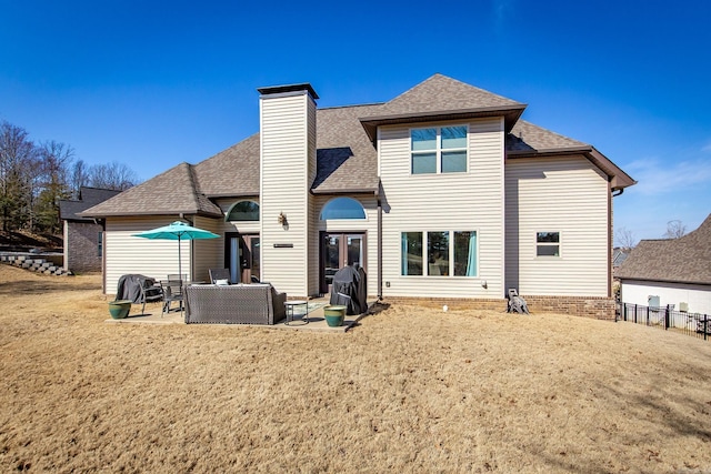 back of property with fence, a chimney, outdoor lounge area, a shingled roof, and a patio area