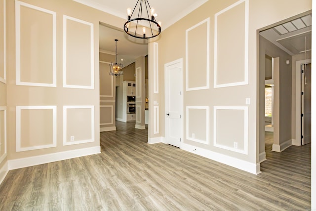 entrance foyer featuring light wood finished floors, a notable chandelier, and baseboards