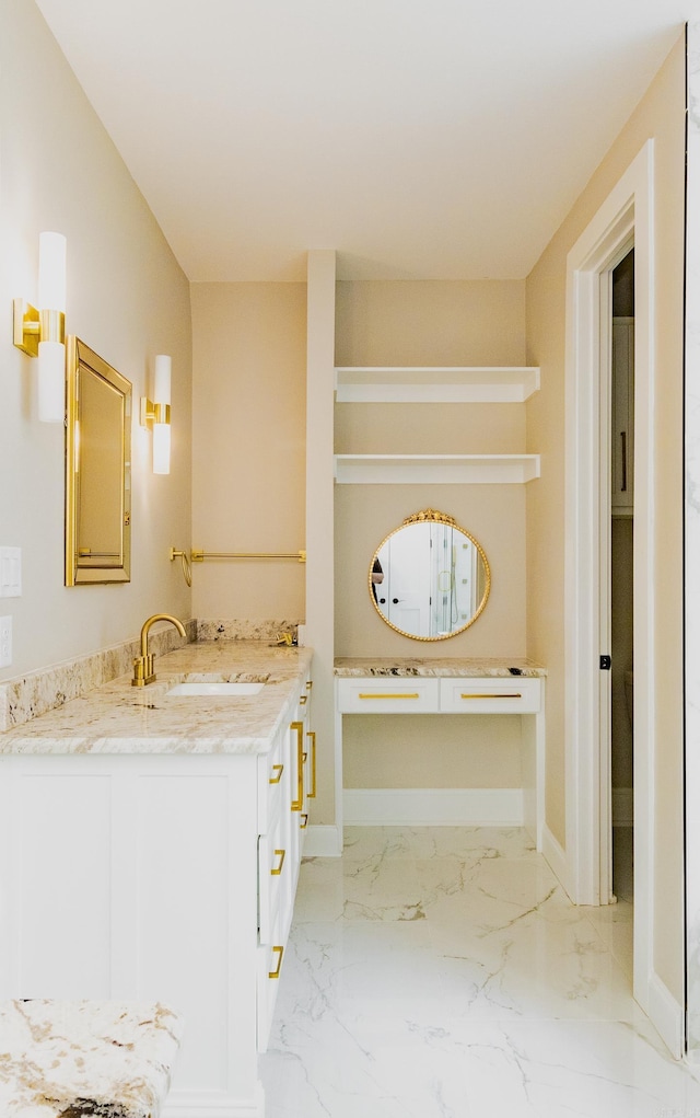 bathroom featuring vanity, marble finish floor, and baseboards