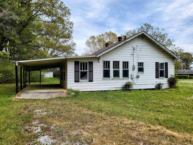 755 Ash St, Prescott, AR 71857 - back of property featuring an attached carport and a yard
