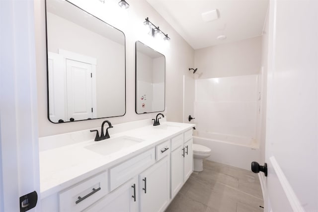 full bath with a sink, toilet, double vanity, and shower / bathing tub combination