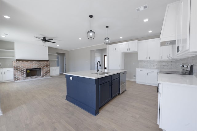 kitchen featuring a ceiling fan, white cabinets, visible vents, a sink, and stainless steel appliances