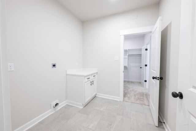 washroom with baseboards, electric dryer hookup, and laundry area
