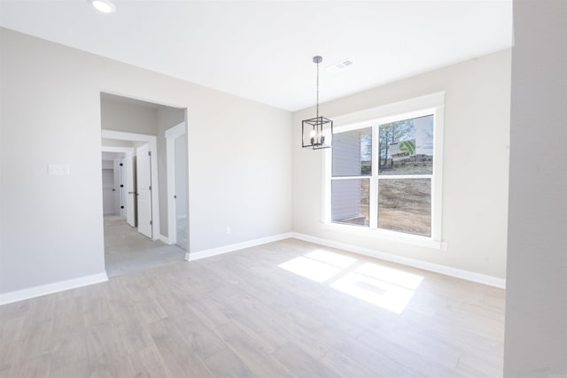 unfurnished dining area with a notable chandelier, baseboards, recessed lighting, light wood-style flooring, and visible vents