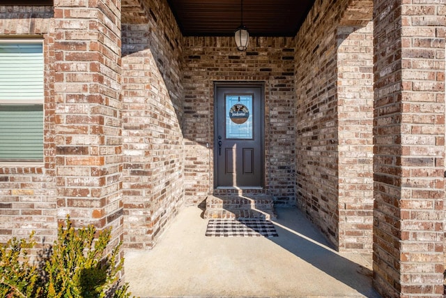 property entrance featuring brick siding