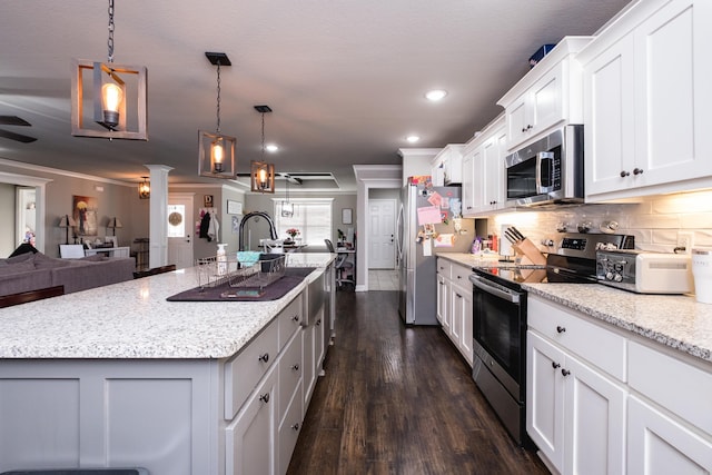 kitchen featuring white cabinets, stainless steel appliances, tasteful backsplash, dark wood-type flooring, and open floor plan