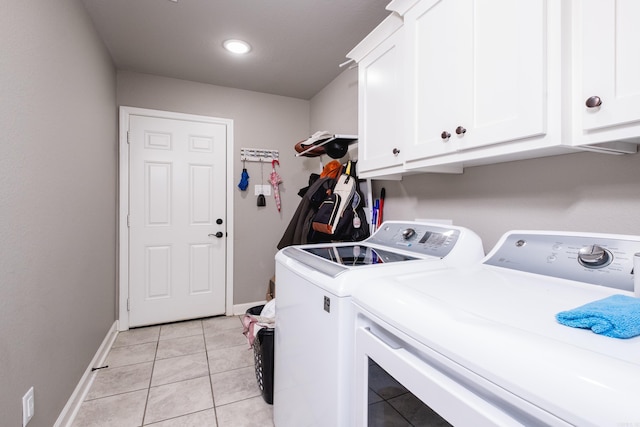 laundry room with baseboards, washer and dryer, cabinet space, and light tile patterned floors