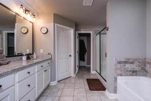full bathroom featuring tile patterned flooring, vanity, a shower stall, a garden tub, and visible vents