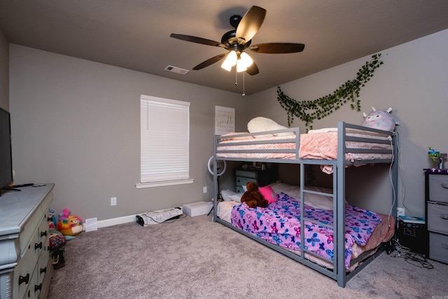 bedroom with baseboards, visible vents, ceiling fan, and carpet