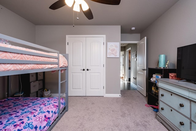 bedroom with a closet, ceiling fan, and carpet