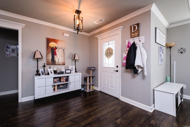 entrance foyer featuring baseboards, dark wood-style floors, ornamental molding, and visible vents