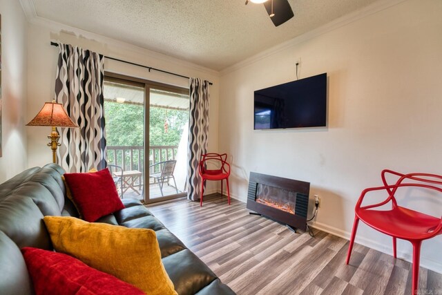 125 Carl Dr, Hot Springs, AR 71913 - living area featuring a textured ceiling, crown molding, a glass covered fireplace, and wood finished floors
