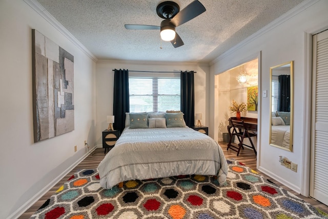 125 Carl Dr, Hot Springs, AR 71913 - bedroom featuring a textured ceiling, baseboards, ornamental molding, wood finished floors, and ceiling fan