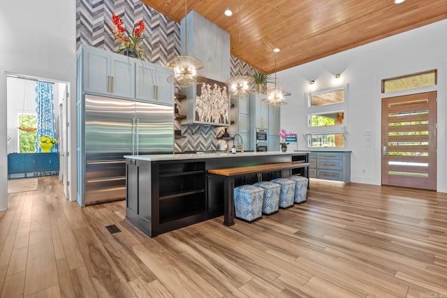 kitchen featuring high vaulted ceiling, open shelves, wooden ceiling, and appliances with stainless steel finishes