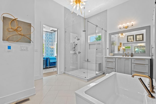 bathroom with visible vents, a soaking tub, a shower stall, vanity, and tile patterned flooring