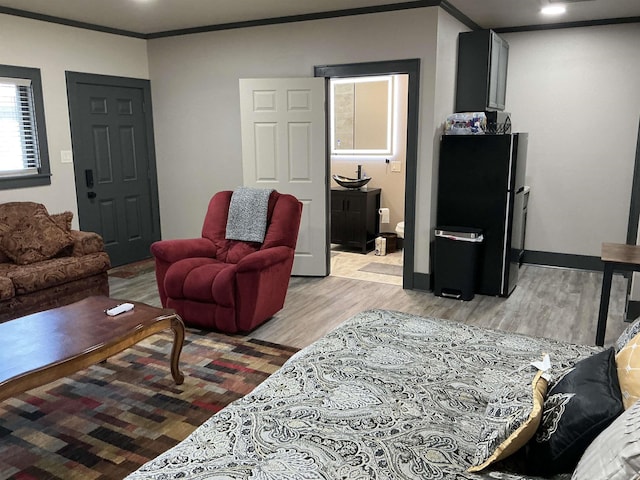206 W High St, Sheridan, AR 72150 - living area featuring light wood-style flooring, crown molding, recessed lighting, and baseboards