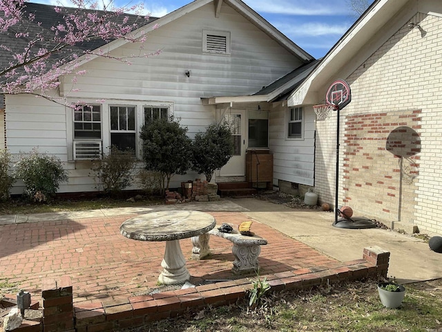 206 W High St, Sheridan, AR 72150 - rear view of property featuring a patio area, entry steps, crawl space, and brick siding