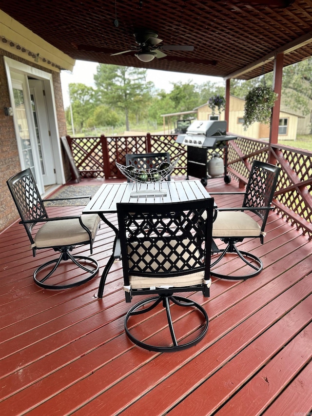 164 Polk Road 714, Mena, AR 71953 - wooden deck featuring a ceiling fan, outdoor dining area, and a grill