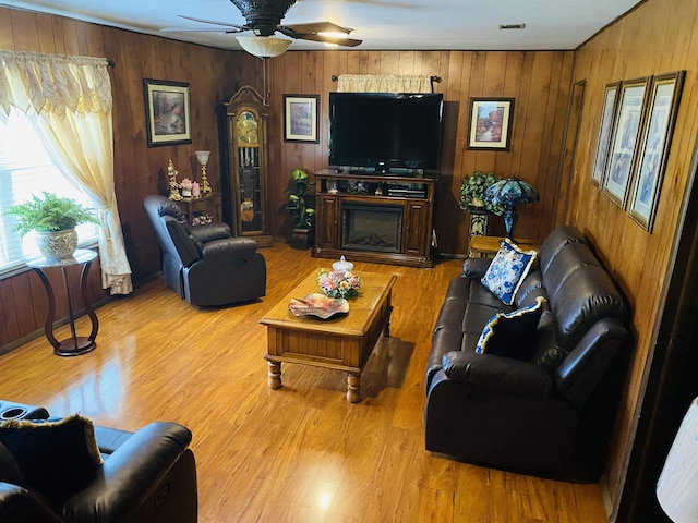 164 Polk Road 714, Mena, AR 71953 - living area with light wood-style flooring, wood walls, and ceiling fan