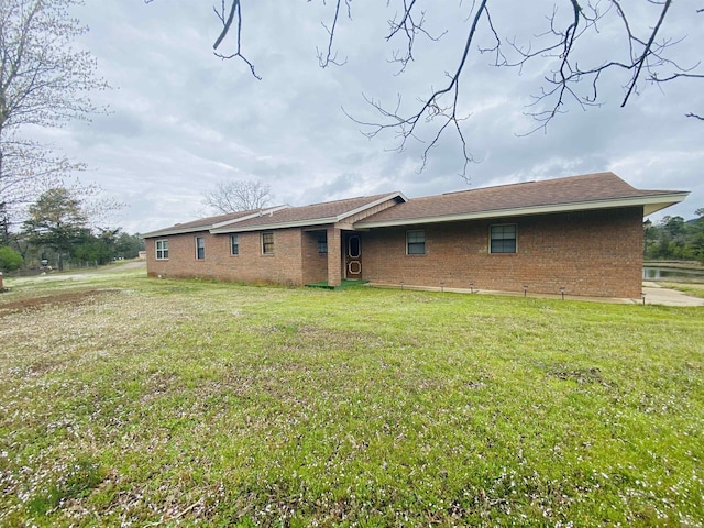 164 Polk Road 714, Mena, AR 71953 - back of property featuring a lawn and brick siding