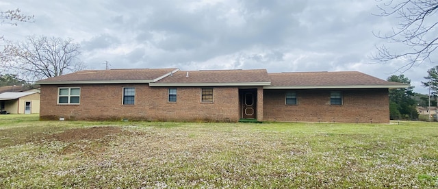 164 Polk Road 714, Mena, AR 71953 - rear view of property featuring brick siding and a lawn