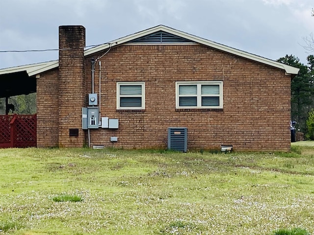 164 Polk Road 714, Mena, AR 71953 - view of side of home featuring a lawn, central air condition unit, and a chimney