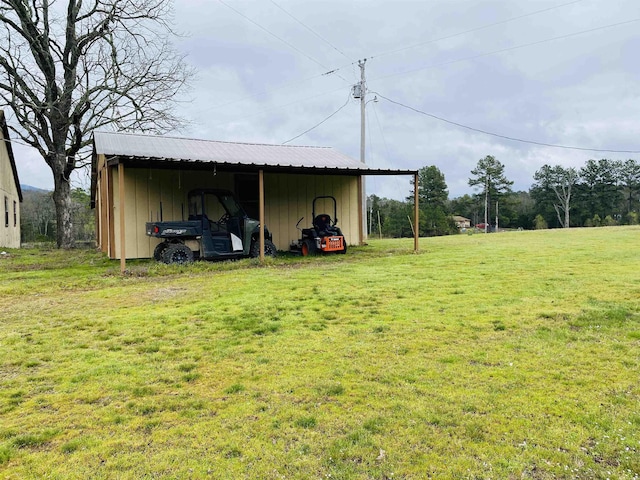 164 Polk Road 714, Mena, AR 71953 - view of pole building with a yard and a carport