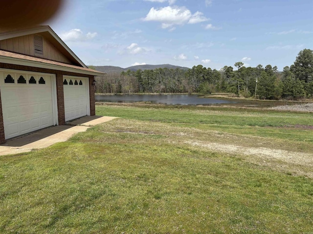 164 Polk Road 714, Mena, AR 71953 - view of yard featuring a wooded view, a water view, and a garage