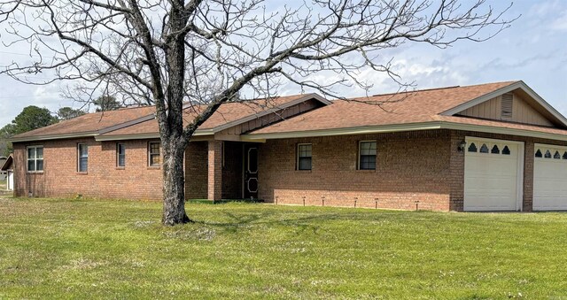 164 Polk Rd Unit 714, Mena, AR 71953 - exterior space featuring an attached garage, brick siding, roof with shingles, and a front yard