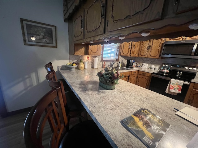 164 Polk Rd Unit 714, Mena, AR 71953 - kitchen with a sink, electric stove, stainless steel microwave, and light countertops