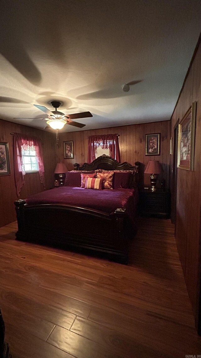 164 Polk Rd Unit 714, Mena, AR 71953 - bedroom featuring wooden walls, wood finished floors, and ceiling fan