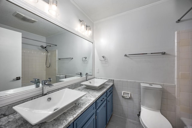 8224 Alvin Ct, Little Rock, AR 72227 - full bathroom featuring toilet, double vanity, ornamental molding, tile walls, and bathtub / shower combination